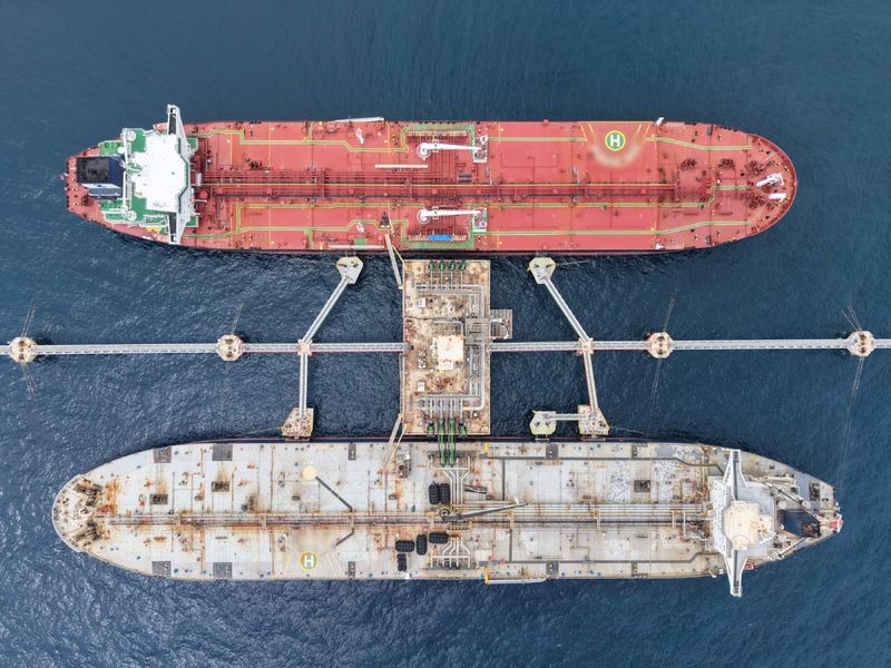 Two tankers moored either side of the Liwathon B.O.S. Sea Island, seen from directly above.