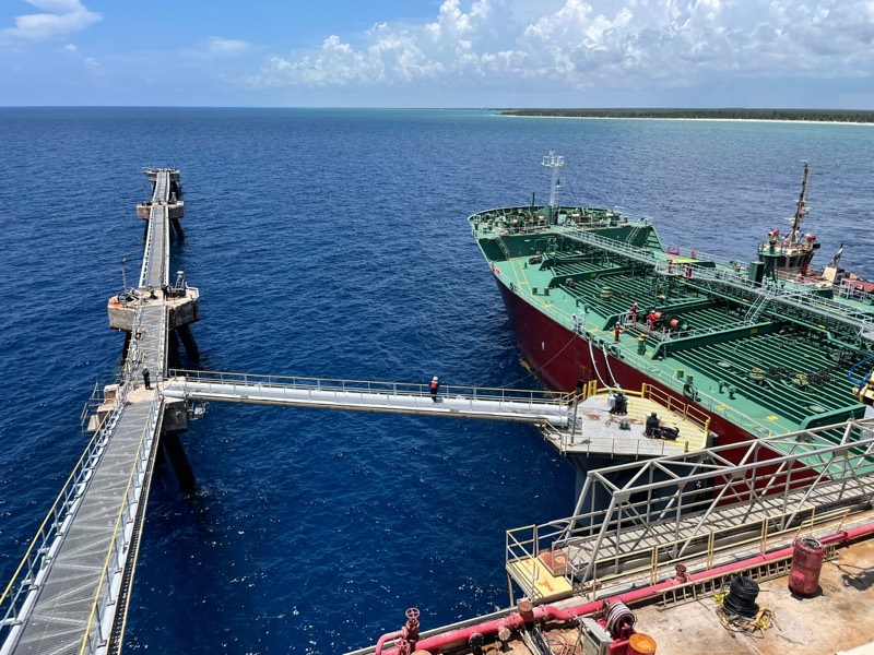 A tanker comes alongside the Liwathon B.O.S. Sea Island, seen from the platform.
