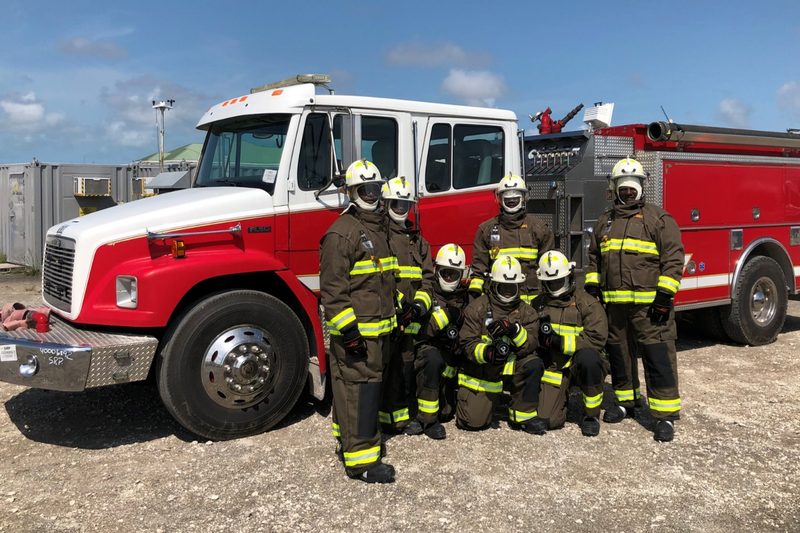 The Liwathon B.O.S. fire crew in full protective gear in front of the terminal’s fire truck at High Rock, Grand Bahama.