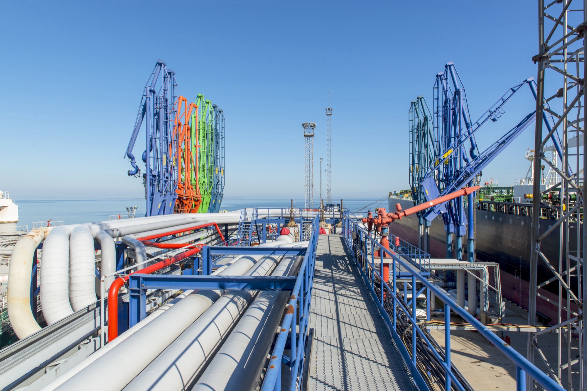 Marine loading arms and a walkway on the Liwathon E.O.S. jetty at Muuga, with a tanker alongside.