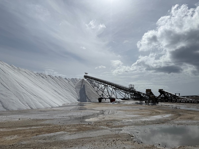 A radial stacker builds the salt stockpile under a cloudy sky at the Lusca Salt works, Great Inagua.