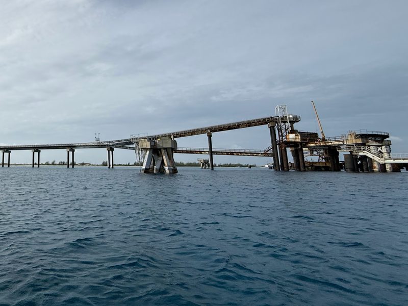 The conveyor trestle and loading head of the Lusca Salt export dock at Man of War Bay, seen from the water.