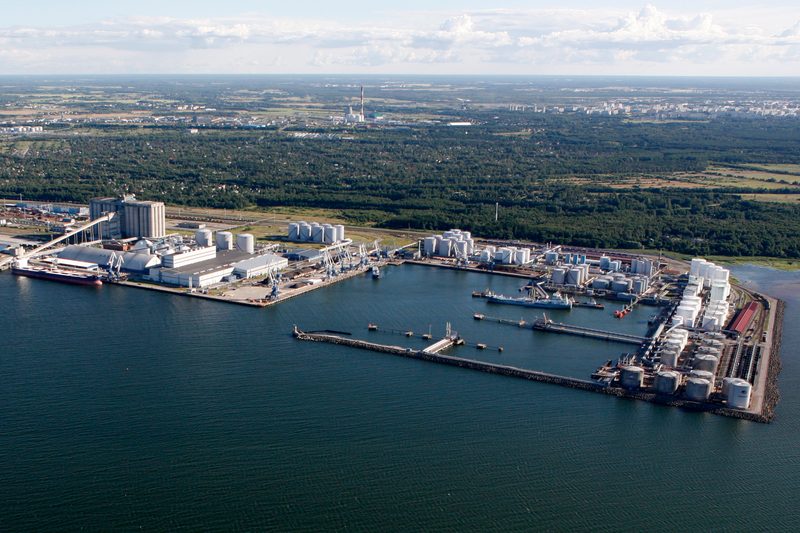 Wide aerial view of Muuga Harbour, Estonia, with the Liwathon E.O.S. tank farms and jetties along the shore.