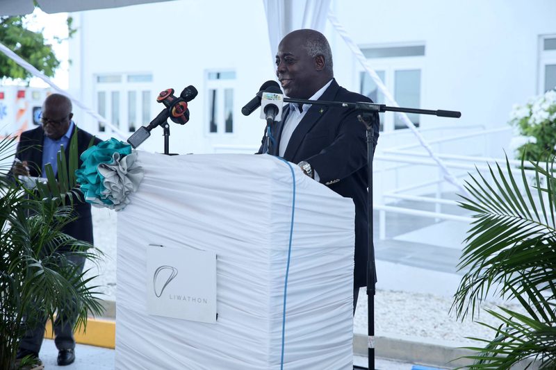 The Prime Minister of The Bahamas speaks at a white-draped lectern bearing the Liwathon logo at the official opening of Liwathon B.O.S. on Grand Bahama, June 2024.